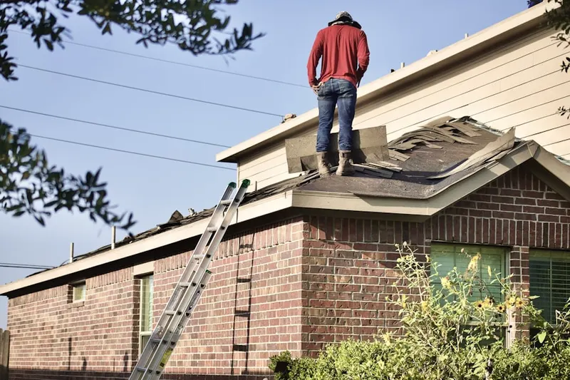 Professional roofer working on a residential roof in Sebille Manor